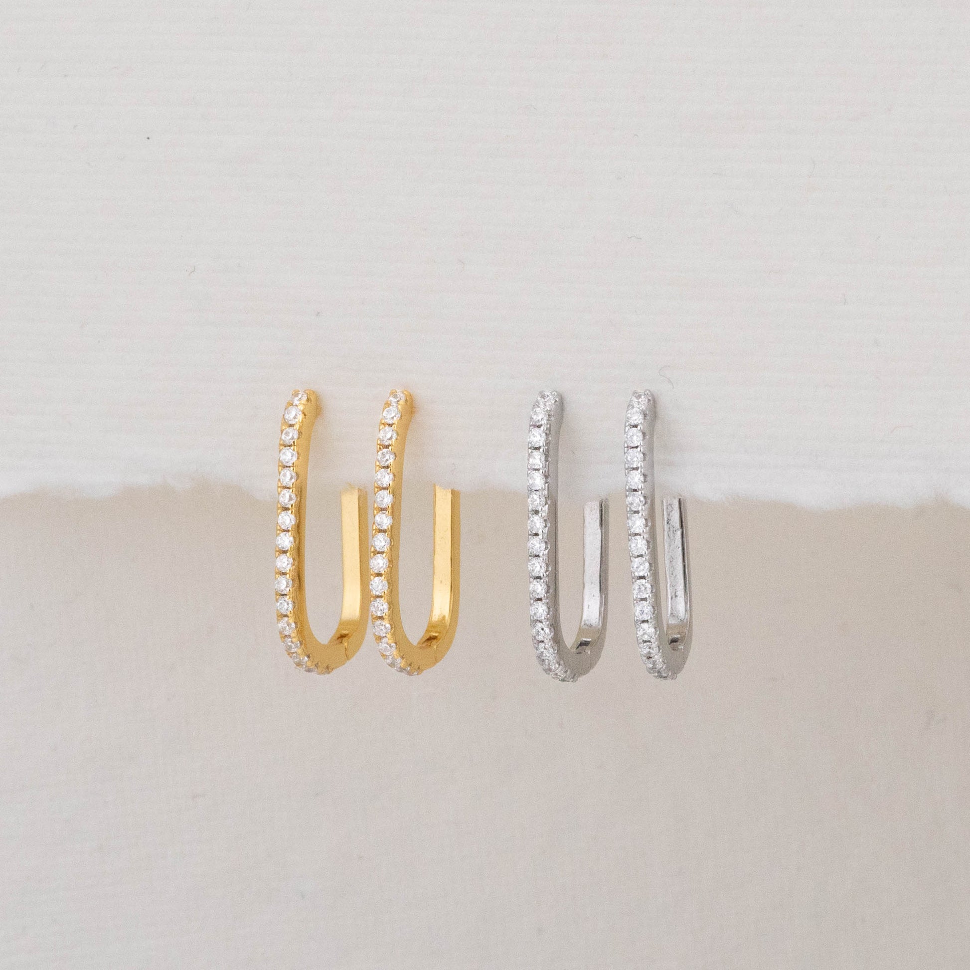 Front view of gold and silver rectangular hoops, showcasing detailed craftsmanship