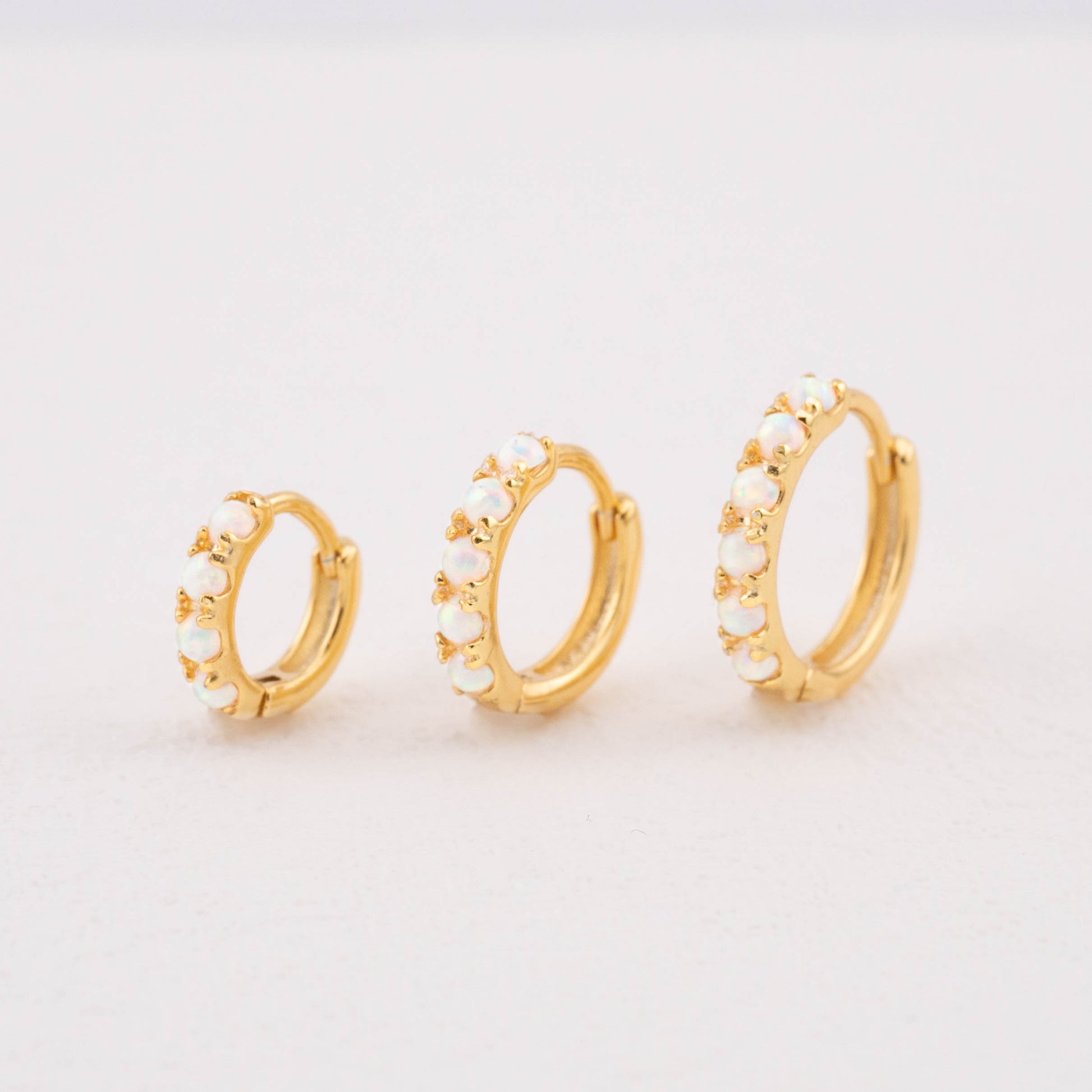Opalescent earrings in gold, showing 6mm, 8mm, and 10mm white opal sizes.